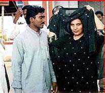 Dhalal Falag al Azmi, right, the Kuwaiti woman who fled for her life, is seen with her husband