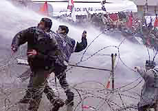 Lebanese and Palestinian student demonstrators throw stones