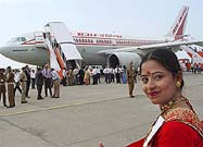 A cabin attendant of Air India smiles near an aircraft