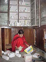 An employee of a wholesale medicine shop goes through cartons
