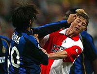 Inter Milan's Alvero Recoba and Jon Dahl Tomasson of Feyenoord push each other