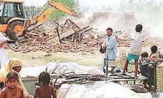 A team of the UT Enforcement Department staff removes illegal constructions in Sector 49 and 50 in Chandigarh on Saturday.