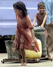 Nine-year-old Meena and her younger brother Abdul carry buckets