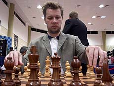 Alexander Khalifman of Russia arranges chess pieces on the board before the start of his match against former junior world champion Joel Lautier of France on the third day of the UAE Chess Grand Prix on Friday.