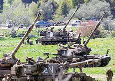 Israeli soldiers prepare 155mm artillery shells on the northern border with Lebanon on Friday.