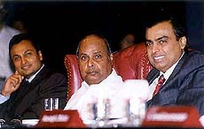 Reliance Group chairman Dhirubhai Ambani is flanked by his two sons Anil Ambani and Mukesh Ambani