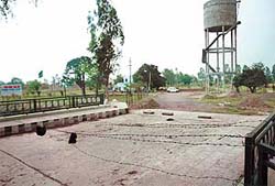 A barbed-wire fence blocks entrance to Shalimar Enclave