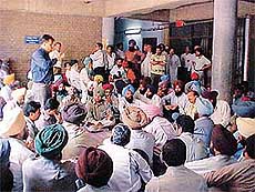 Members of the Revenue Patwar Union hold a dharna in front of the New Courts in Ludhiana on Monday. 