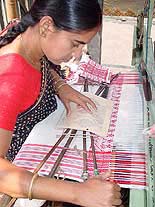 With Bihu nearing, an Assamese woman busy in her loom