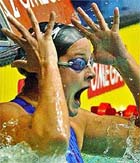 Lindsay Benko of the USA screams as she reacts after her victory in a women's 200-metre freestyle event