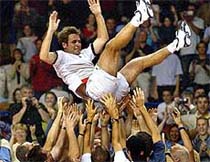 Fabrice Santoro of France is thrown into the air by members of the French Davis Cup team 