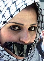 A Jordanian woman Abeer al-Issa, tapes up her mouth during a demonstration aganist Israeli actions in the West Bank, in Amman on Monday.