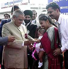 Prime Minister Atal Behari Vajpayee being welcomed by a kid