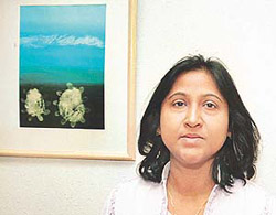 Sangeeta Gupta from Delhi with her painting at IndusInd Art Gallery in Chandigarh on Thursday.