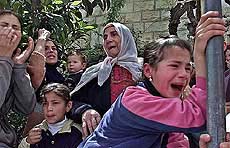 Relatives of a Palestinian killed in recent days cry as they carry the body during the funeral in the West Bank City of Ramallah on Thursday.