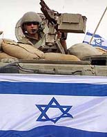 An Israeli soldier stands in an armoured personnel carrier as they enter into the Bethlehem area on Thursday.