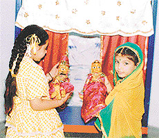 Kids admire dolls at a toyroom in KVM School, Ludhiana, on Friday.