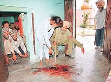 Trilochan Singh (13) points towards the blood-splattered floor in Nabha village, Zirakpur, on Saturday. 