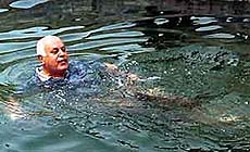 Jammu and Kashmir Chief Minister Farooq Abdullah takes a dip in the Dal Lake