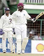 West Indies captain Carl Hooper lifts his bat after scoring a double century