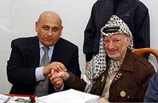 Egyptian Foreign Minister Ahmed Maher speaks with Palestinian leader Yasser Arafat
