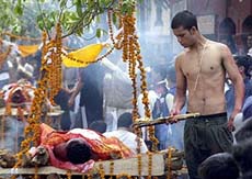 Janakraj Basnyet, the son of murdered Nepalese Deputy Superintendent of Police Dhana Bahadur Basnyet, lights the funeral pyre