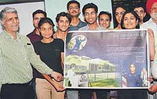 Students of Punjab Engineering College hand over a banner to Principal Baljeet S. Kapoor to be forwarded to Kalpana Chawla, an alumnus of the college, conveying success in her mission aboard space shuttle STS-107 (July, 2002) in Chandigarh on Monday.