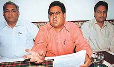 Mr Mahavir Prasad, general secretary of the Chandigarh Marble and Stone Association, (centre) addresses a press conference in Chandigarh on Monday.