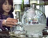 Japanese sake rice wine is poured into soccer ball-shaped bottles