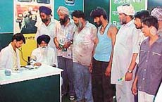 Truck drivers being examined by experts at a medical check-up camp organised by British Petroleum here today.