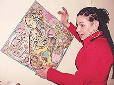 Katazyna Pollok, artist from Germany, explains one of her paintings displayed at Pracheen Kala Kendra in Sector 35, Chandigarh, on Thursday.