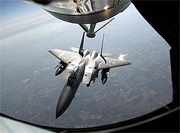 A U.S F-15 fighter peals away from the nozzle of a refueling plane over Washington, D.C.