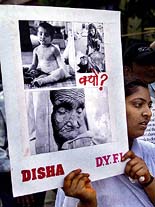 A human rights activist holds aloft a placard