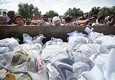 Palestinians bury their dead in mass graves
