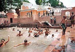 Devotees take a holy dip at �Mundan Ghat� on the concluding day of Navratra Mela at Mansa Devi Temple, Panchkula