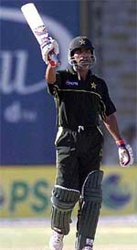 Pakistani batsman Yousuf Youhana waves his bat after scoring his century in Karachi