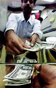 A cashier gives dollars to a buyer