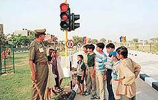 A policeman explains traffic rules to kids at the Children�s Traffic Park inaugurated by the Haryana Chief Minister in Sector 12, Panchkula, on Tuesday.
