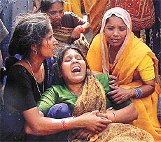 The mother of the child who was killed being consoled by her relatives