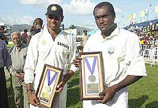 VVS Laxman of India, left, and West Indies captain Carl Hooper, right, hold up plaques 