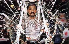 A devotee carries a ceremonial harness