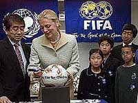 Nane Annan, wife of UN Secretary-General Koffi Annan, signs her autograph on a World Cup official soccer ball