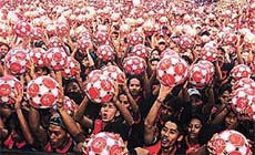 Some 2002 men hold up soccer balls in Jakarta on Sunday. 