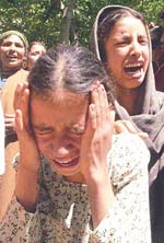 Relatives of Gulshan Bano wail at Chachakoot village in Anantnag on Monday. 