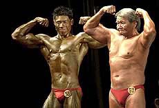 Chung Teng Soon, 66, right, poses next to Elvin Chong during Singapore's National Bodybuilding Championships