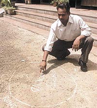 A man pointing out the spot where Parvinder Arora was shot dead at Model Town 