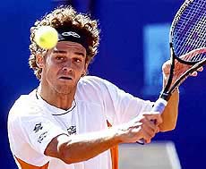Three times French Open champion Gustavo Kuerten of Brazil returns a ball