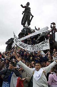 French students shout slogans as they display banners to encourage citizens to vote on the Republic Statue