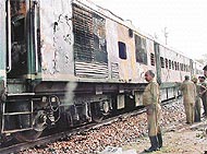 A Railway employee inspects the burnt engine