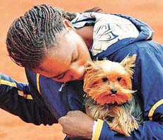 US tennis player Venus Williams cuddles her pet dog